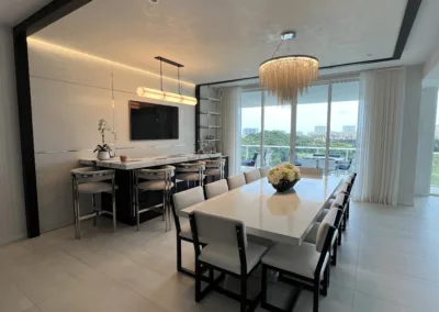 A white dining room with a view of the ocean.